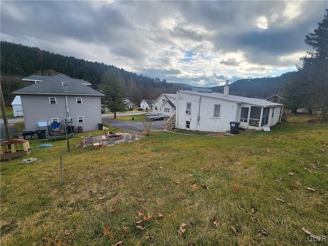 4400 Little Gap Rd, Lower Towamensing Tp, PA 18058 - back of house with a sunroom, a yard, a chimney, and an outdoor fire pit