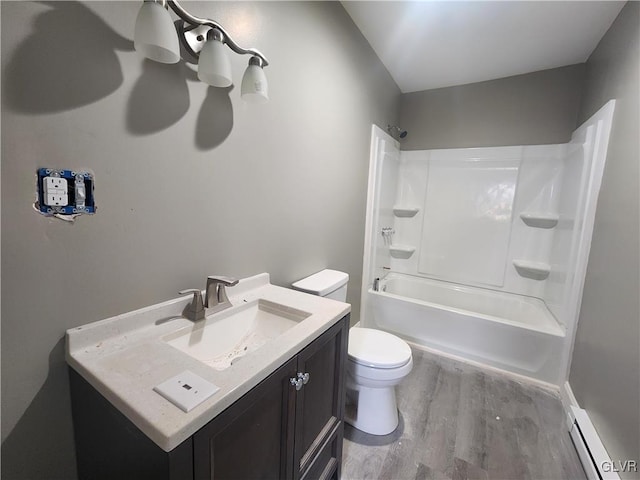 full bathroom featuring vanity, a baseboard heating unit, shower / tub combination, hardwood / wood-style flooring, and toilet