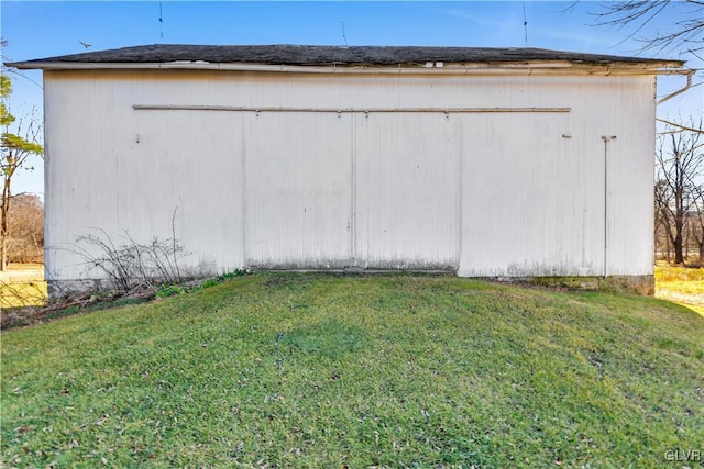 view of outbuilding with a lawn