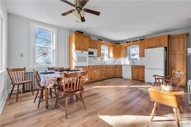 kitchen featuring decorative backsplash, ceiling fan, white appliances, and light wood-type flooring