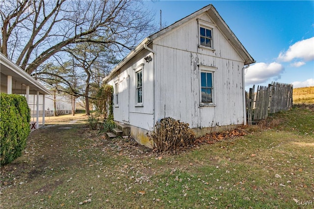 view of side of home featuring a yard