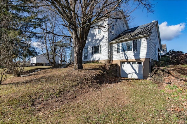 view of side of home featuring a garage