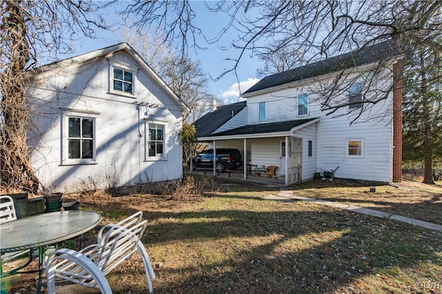 back of house with a yard