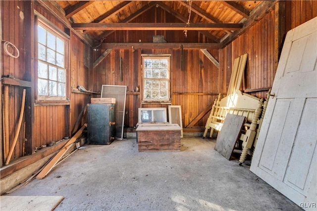 misc room featuring vaulted ceiling with beams and wooden walls