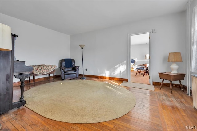 sitting room with hardwood / wood-style floors and radiator