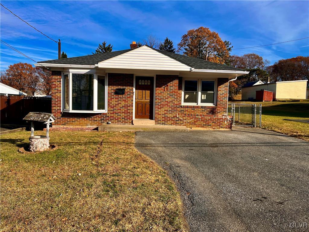 bungalow-style home with a front lawn