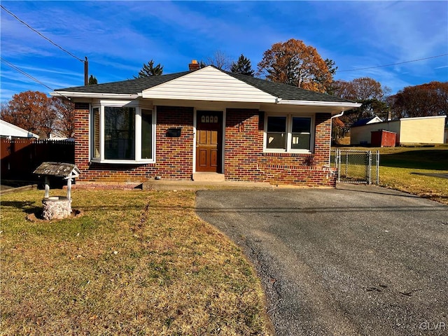 bungalow-style home with a front lawn