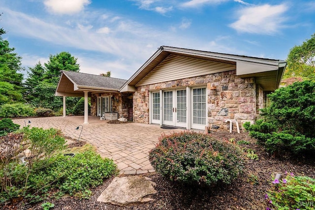 rear view of property featuring french doors and a patio area