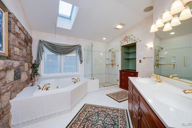 bathroom with tile patterned flooring, shower with separate bathtub, vanity, and vaulted ceiling with skylight