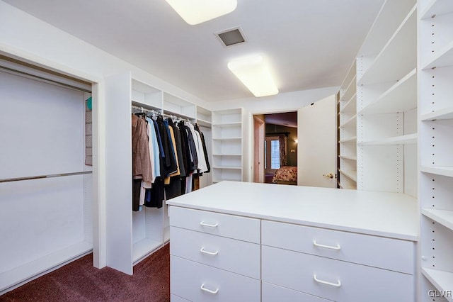 spacious closet featuring dark carpet