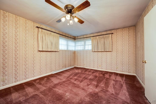 carpeted spare room featuring ceiling fan