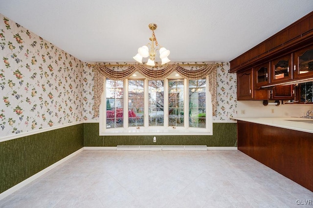 unfurnished dining area featuring a chandelier and baseboard heating