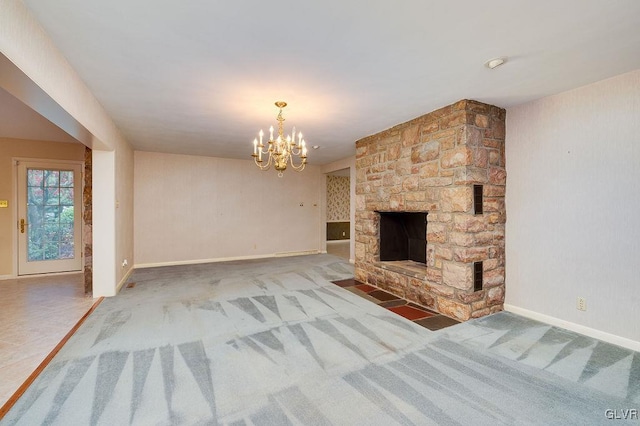 unfurnished living room with carpet floors, an inviting chandelier, and a stone fireplace