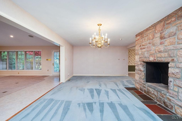 unfurnished living room featuring a notable chandelier, a stone fireplace, and carpet floors