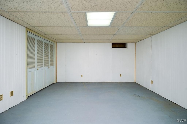 basement with a paneled ceiling