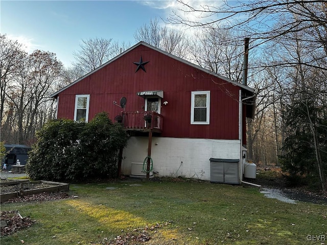 view of side of home with a lawn