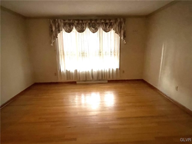 spare room with hardwood / wood-style floors