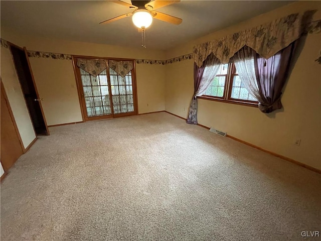 empty room featuring carpet flooring and ceiling fan