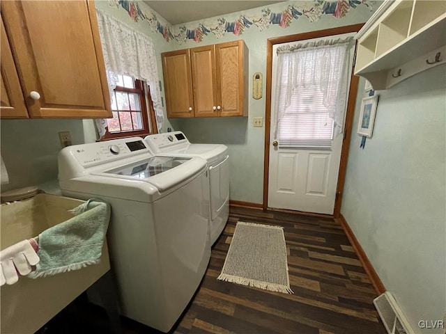 laundry area with cabinets, dark hardwood / wood-style flooring, and separate washer and dryer