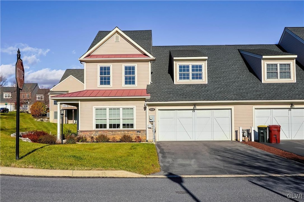 view of front of property featuring a front yard and a garage