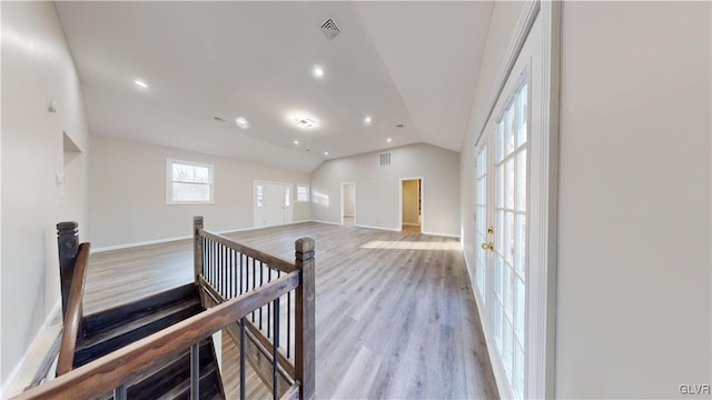 corridor featuring lofted ceiling and light wood-type flooring