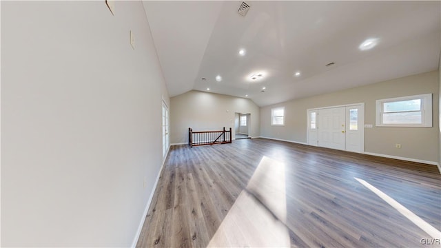 unfurnished living room featuring light hardwood / wood-style flooring, plenty of natural light, and lofted ceiling