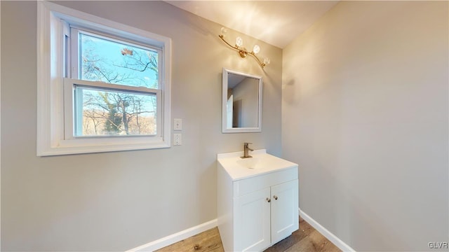 bathroom with vanity, wood-type flooring, and lofted ceiling