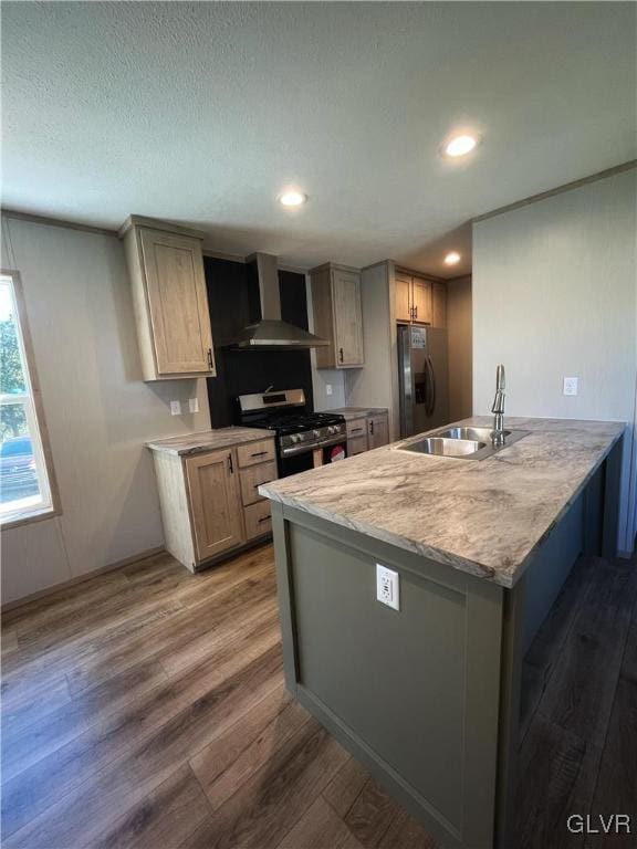 kitchen with wall chimney exhaust hood, stainless steel appliances, dark wood-type flooring, sink, and light brown cabinets