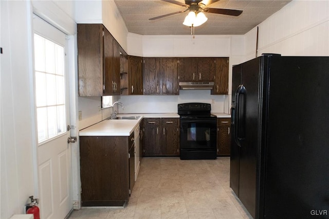 kitchen featuring black appliances, dark brown cabinets, sink, and a wealth of natural light