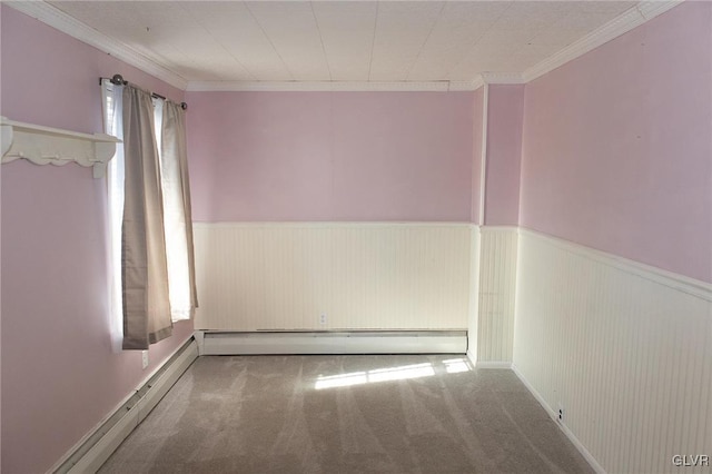 spare room featuring baseboard heating, crown molding, plenty of natural light, and carpet floors