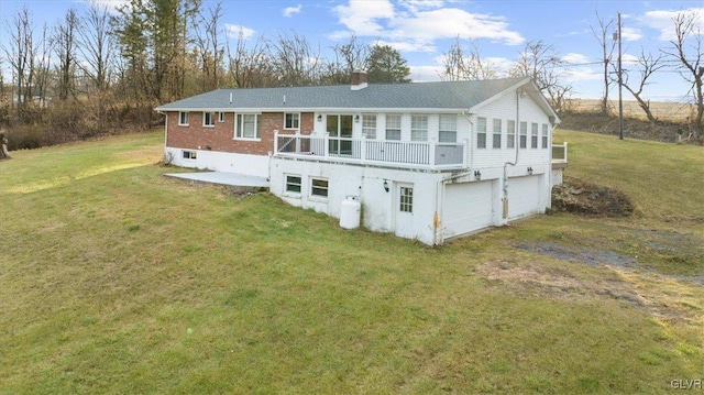 back of house with a garage, a yard, and a deck