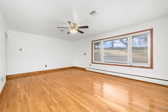 spare room with ceiling fan, a baseboard radiator, and light hardwood / wood-style floors