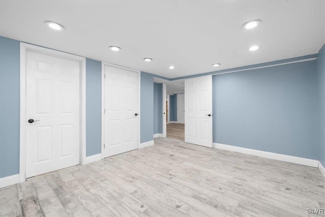 basement with light hardwood / wood-style floors