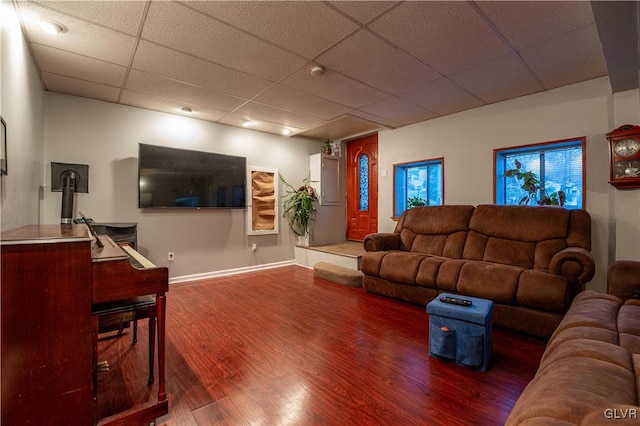 living room featuring a drop ceiling and wood-type flooring