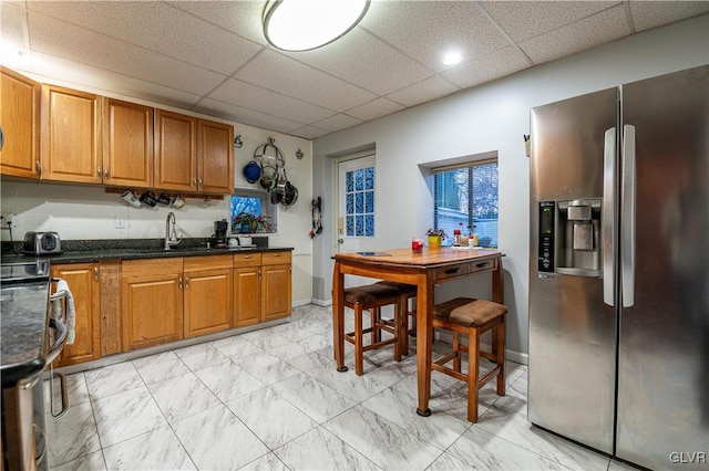 kitchen with a paneled ceiling, sink, and appliances with stainless steel finishes