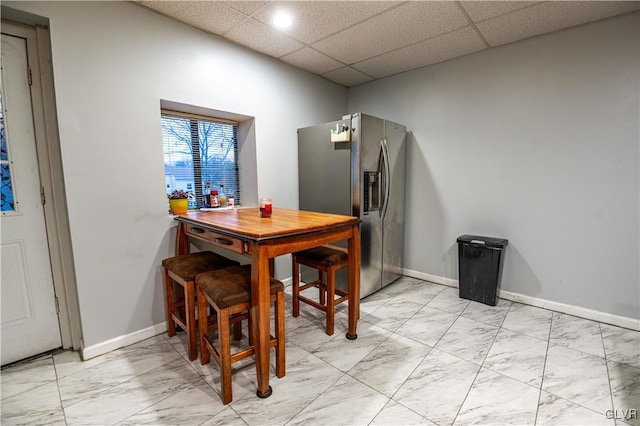 dining room with a drop ceiling