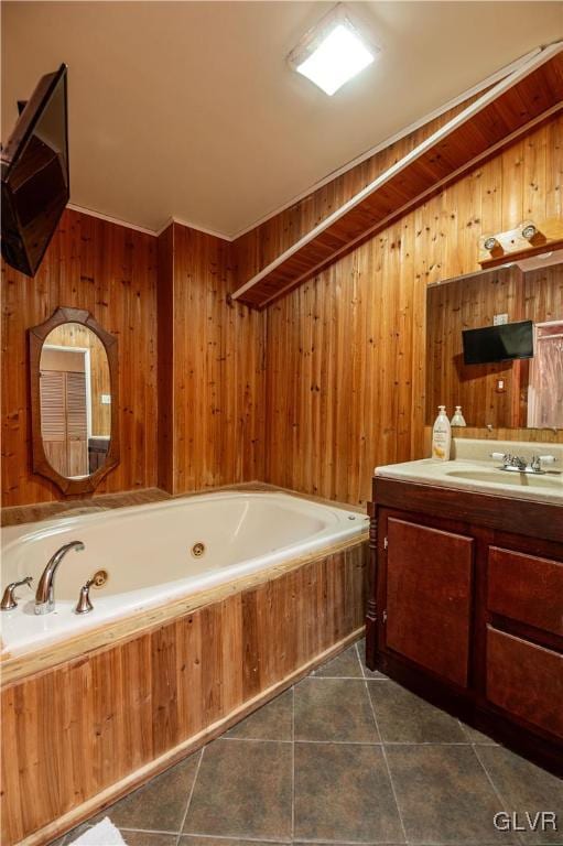 bathroom featuring tile patterned flooring, vanity, wood walls, and a tub to relax in