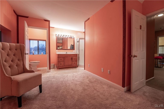 sitting room featuring light colored carpet