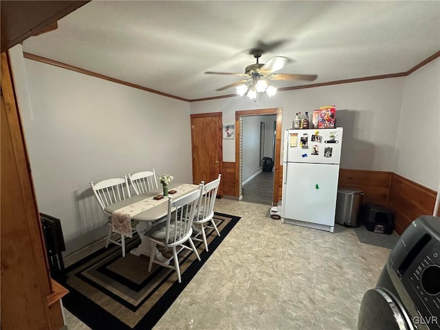 dining room with washer / dryer, ceiling fan, and ornamental molding