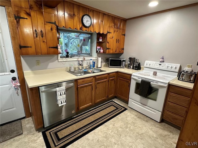 kitchen with sink, ornamental molding, and stainless steel appliances