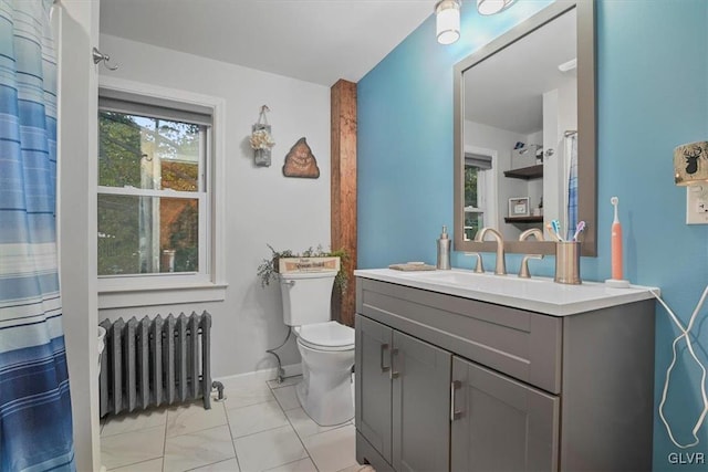 bathroom featuring vanity, toilet, and radiator