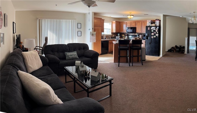 carpeted living room featuring ceiling fan