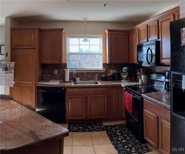 kitchen with black appliances, decorative backsplash, light tile patterned floors, and sink