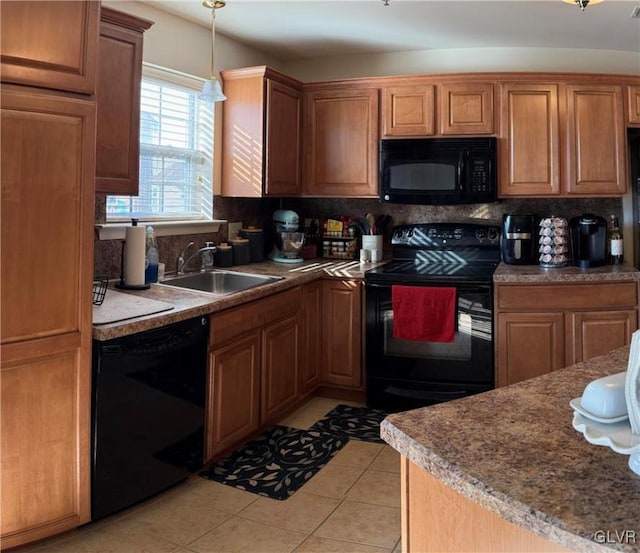 kitchen with backsplash, black appliances, sink, hanging light fixtures, and light tile patterned floors