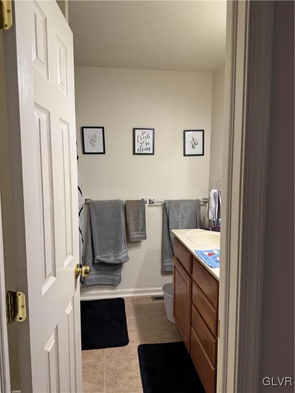 bathroom with tile patterned floors, vanity, and toilet