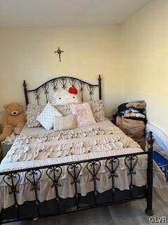 bedroom with dark hardwood / wood-style flooring