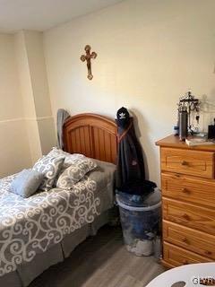 bedroom with dark wood-type flooring