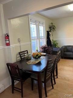 dining space with wood-type flooring