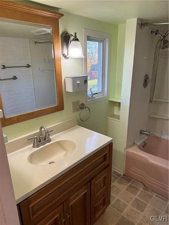 bathroom featuring vanity and tiled shower / bath