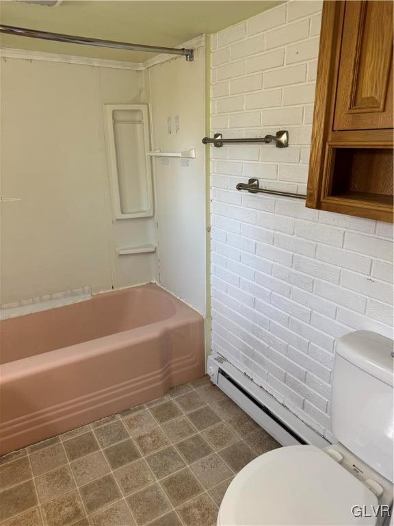 bathroom featuring bathtub / shower combination, toilet, and baseboard heating